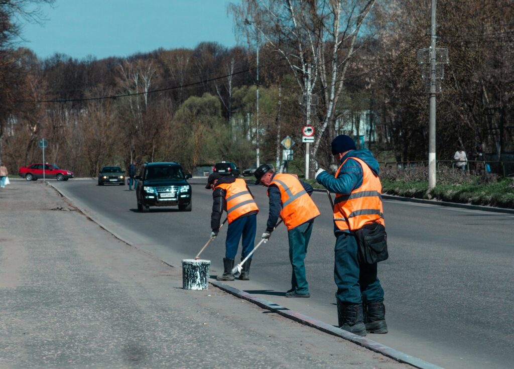 road workers cleaning up the road
