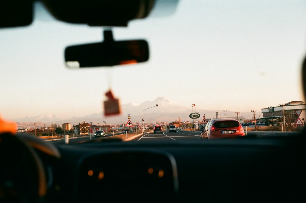 person driving a car on highway road