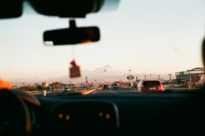 person driving a car on highway road
